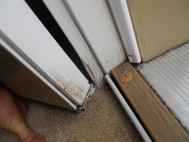 Photo on left shows door swinging in. Water has been running down the door and wicking under the door sweep
