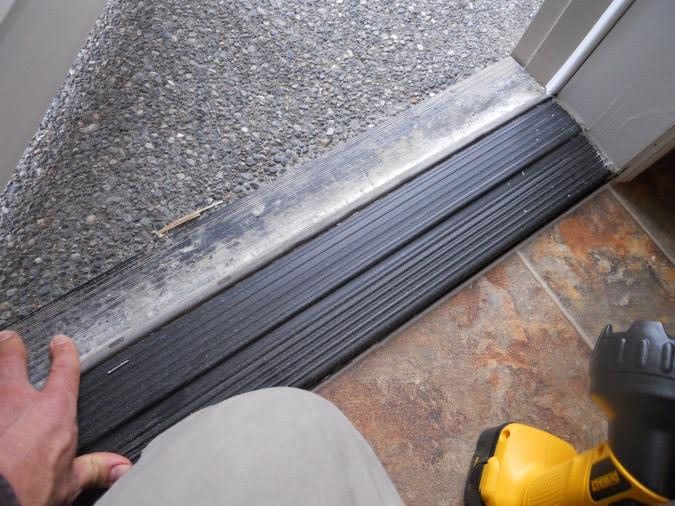 The threshold of a door, shown during a home inspection