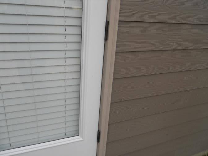 The hinges of a door, shown during a home inspection