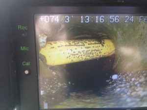 Photo from a sewer scope of a gas line running through a sewer pipe!