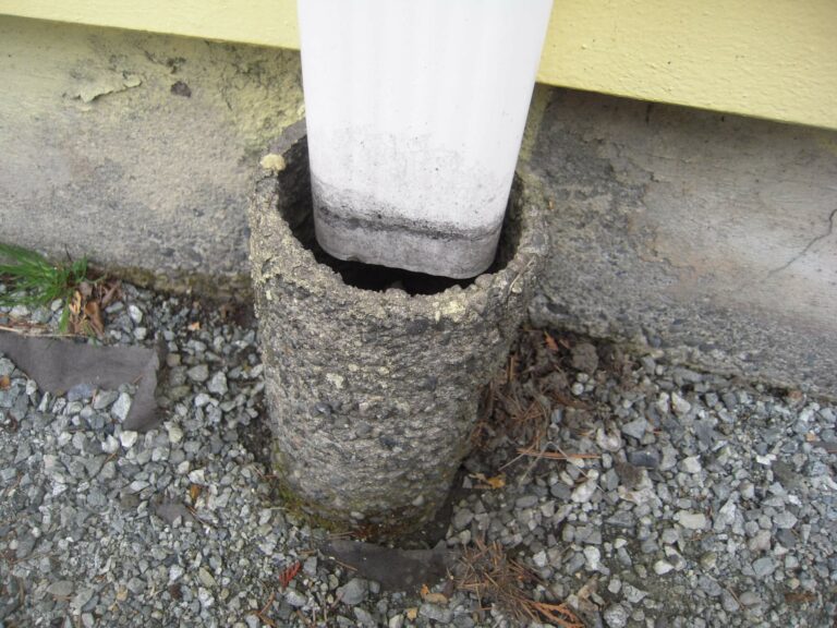 A gutter draining into a concrete pipe. Useful to prevent moisture damage around a house